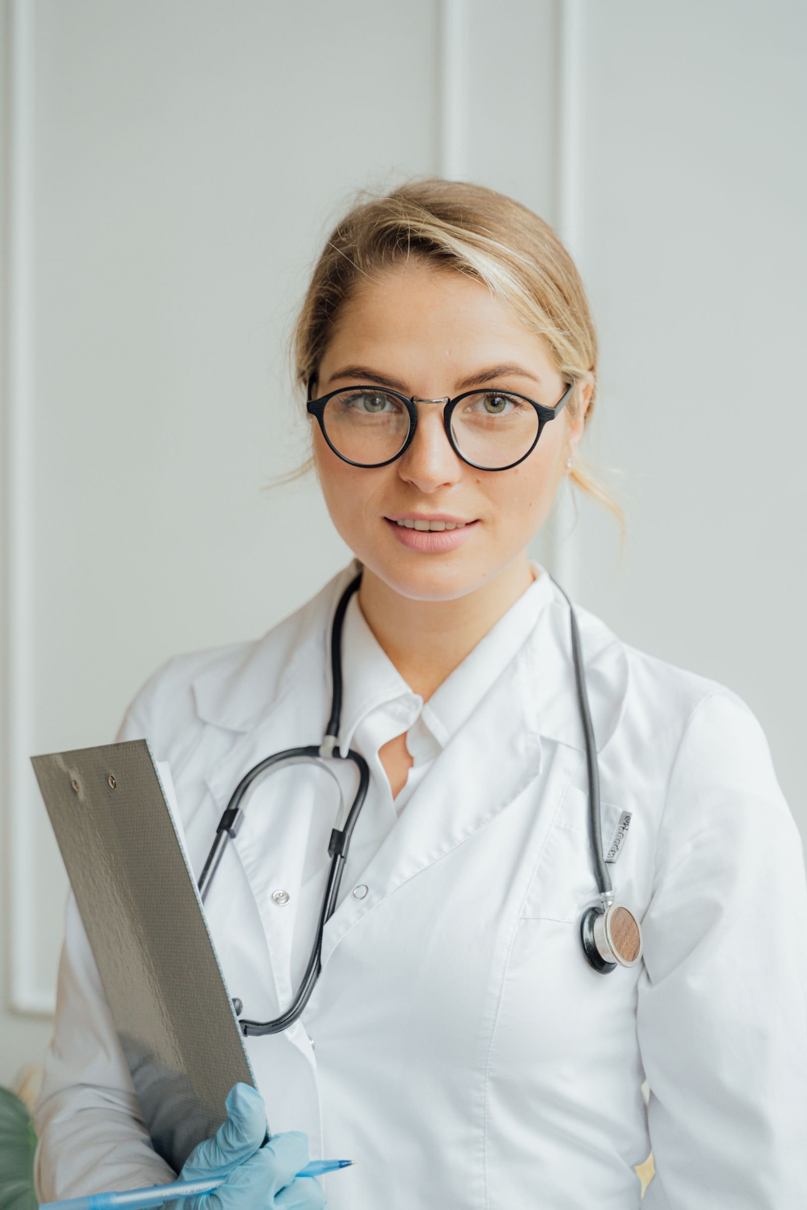 Healthcare professional with a clipboard in a clinical setting
