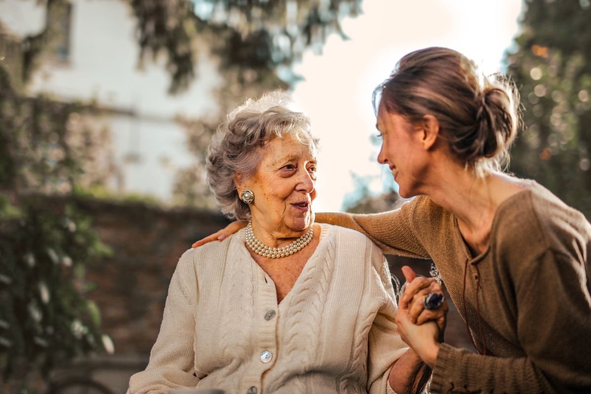 Caregiver supporting an older adult at home